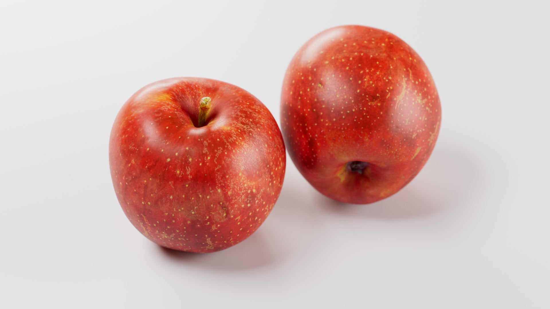 Two red apples on a white background