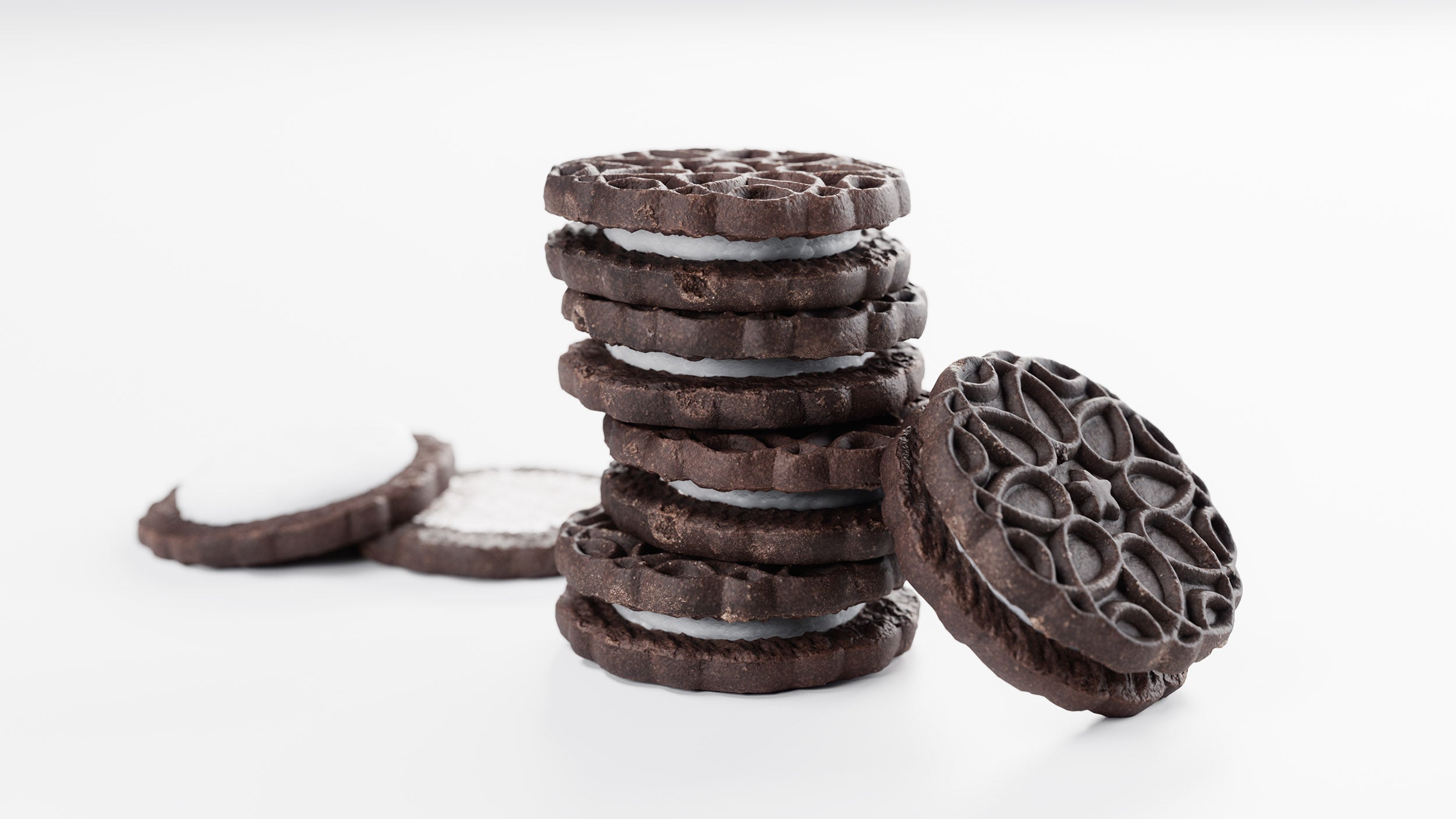 Stack of chocolate cookies with cream filling on a white background